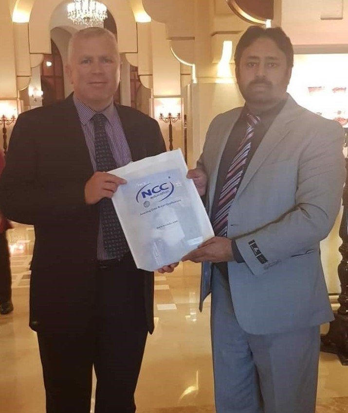 Andrew Rennie (Regional Director of NCC UK) is presenting NCC UK Kit to Asif Amin
